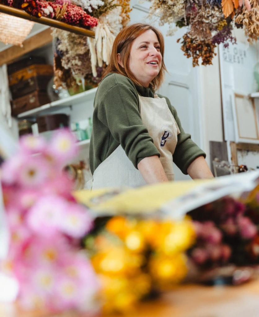 Smiling florist in her floral design studio near Toulouse, France